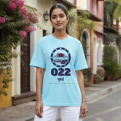 022 Mumbai STD code oversized cotton T-shirt in baby blue, women's front view in a Bandra lane, Bonzo Peter's