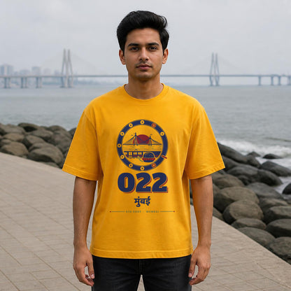 022 Mumbai STD code oversized cotton T-shirt in golden yellow, men's front view at Bandra Bandstand, Bonzo Peter's