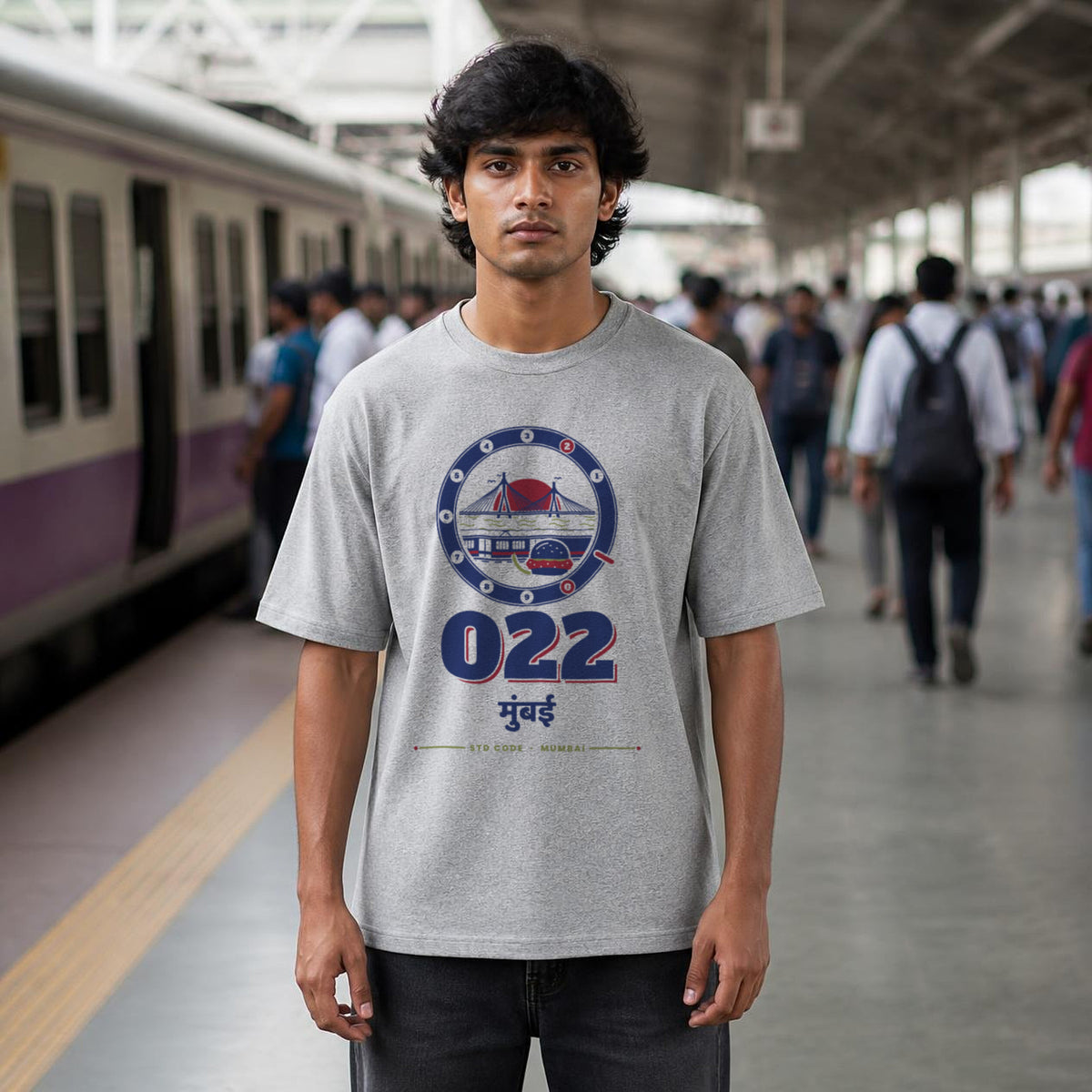 022 Mumbai STD code oversized cotton T-shirt in grey melange, men's front view on a local-train platform, Bonzo Peter's