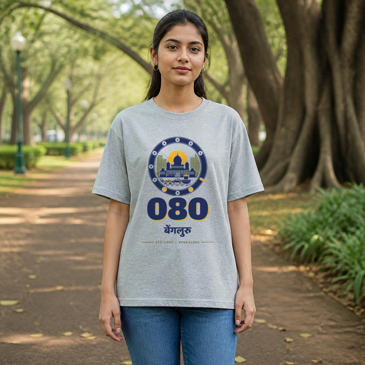 080 Bengaluru STD code oversized cotton T-shirt in grey melange, women's front view in Cubbon Park, Bonzo Peter's