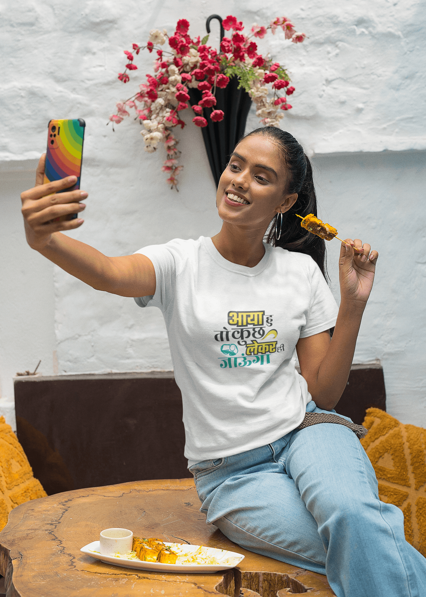 Woman taking a selfie while wearing unisex AYA HU KUCH TOH LEKE JAUNGA T-shirt and eating dessert