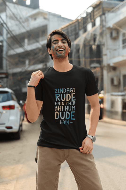 Unisex t-shirt with "Zindagi Rude Hain Phir Bhi Hum Dude Hain" design, man smiling in urban setting
